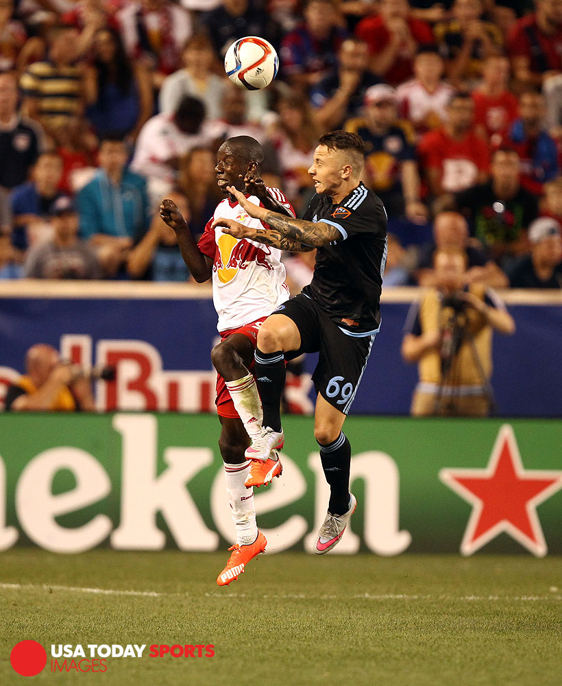Aug 9, 2015; Harrison, NJ, USA; New York Red Bulls defender Kemar Lawrence (92) and New York City FC defender Angeli?o (69) battle for a ball during the second half at Red Bull Arena. Mandatory Credit: Danny Wild-USA TODAY Sports
