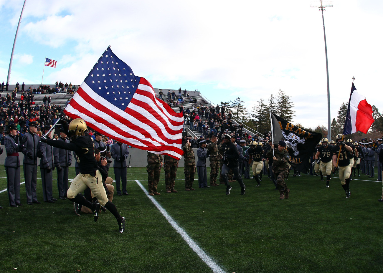 Nov 14, 2015; West Point, NY, USA; Army Black Knights defensive back Jared Rogers (18) carries an American flag on to the field alongside a cadet carrying a French flag before a game against Tulane at Michie Stadium. The tribute comes a day after terrorist attacks hit Paris, France. Mandatory Credit: Danny Wild-USA TODAY Sports