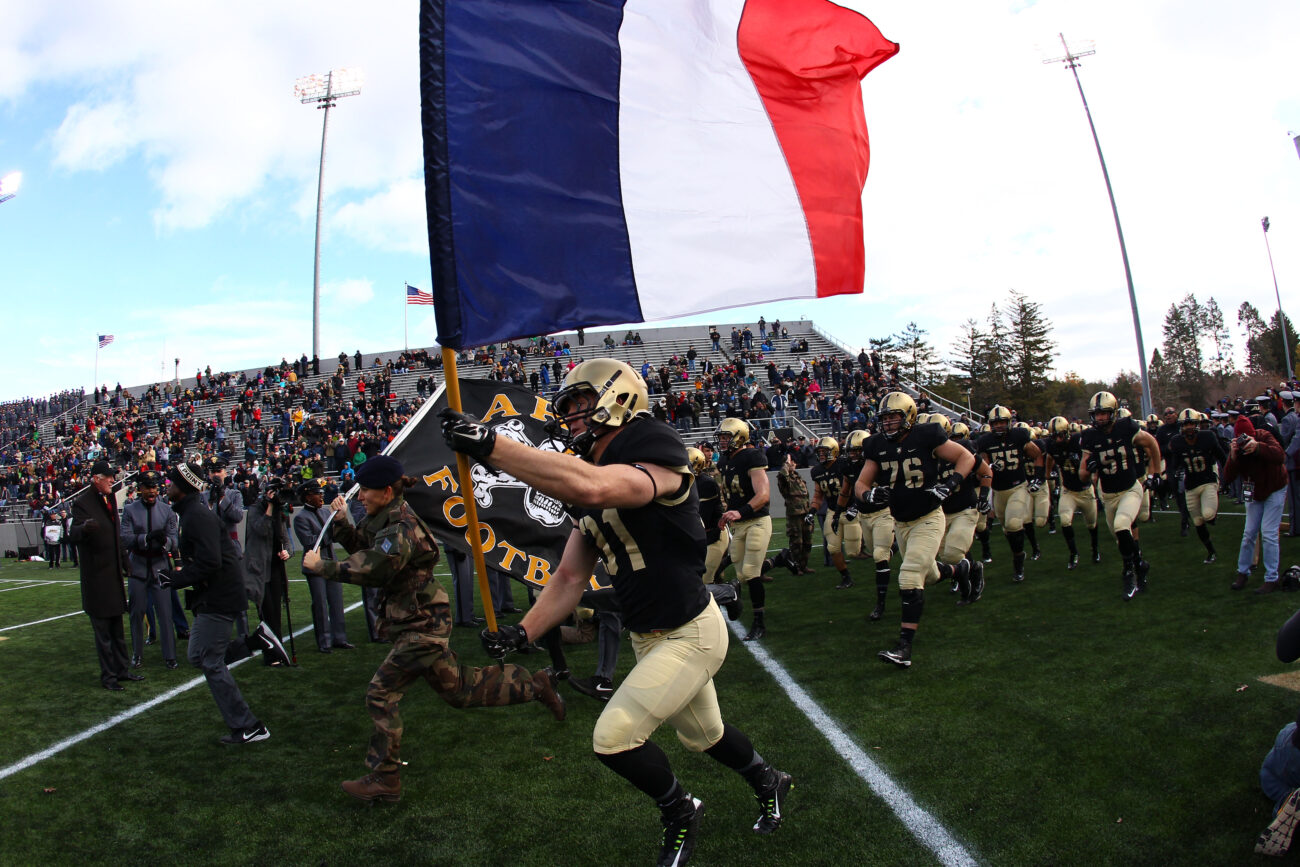 Nov 14, 2015; West Point, NY, USA; Army Black Knights defensive back Caleb McNeill (31) carries a French flag on to the field alongside a French exchange cadet before a game against the Tulane Green Wave at Michie Stadium. Army honored the French a day after terrorist attacks in Paris, France. Mandatory Credit: Danny Wild-USA TODAY Sports